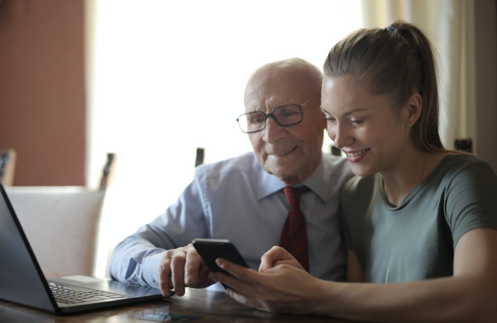 Grandfather and granddaughter surfing the web